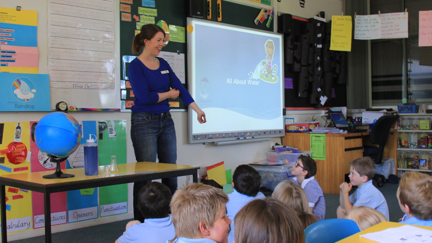 Our educator standing in front of a classroom of students