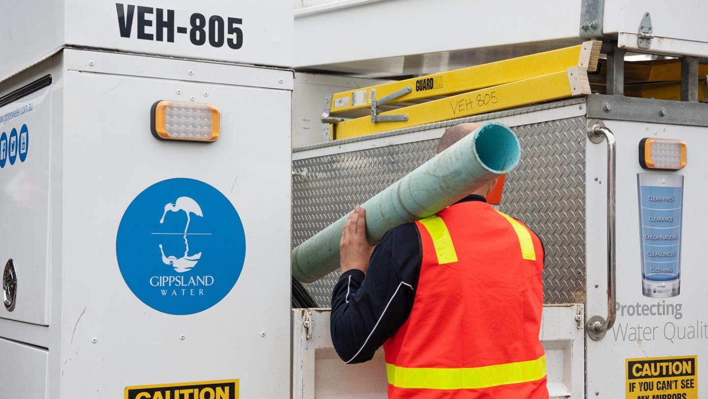 Gippsland Water team member removing pipe from truck