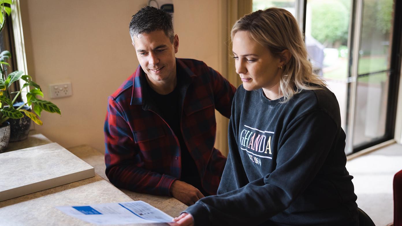 Man and woman look at Gippsland Water bill. 