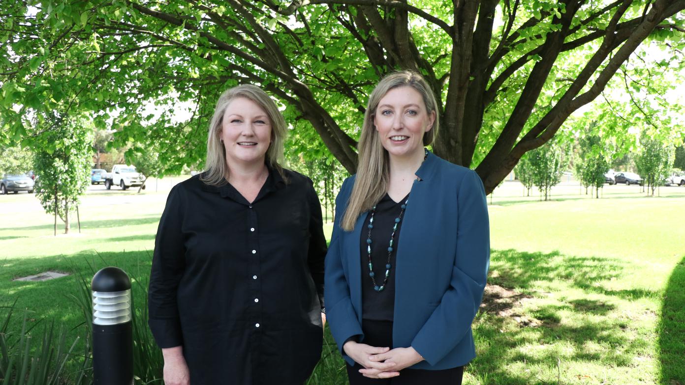 Sarah Cumming and Leigh Kennedy stand side by side smiling.