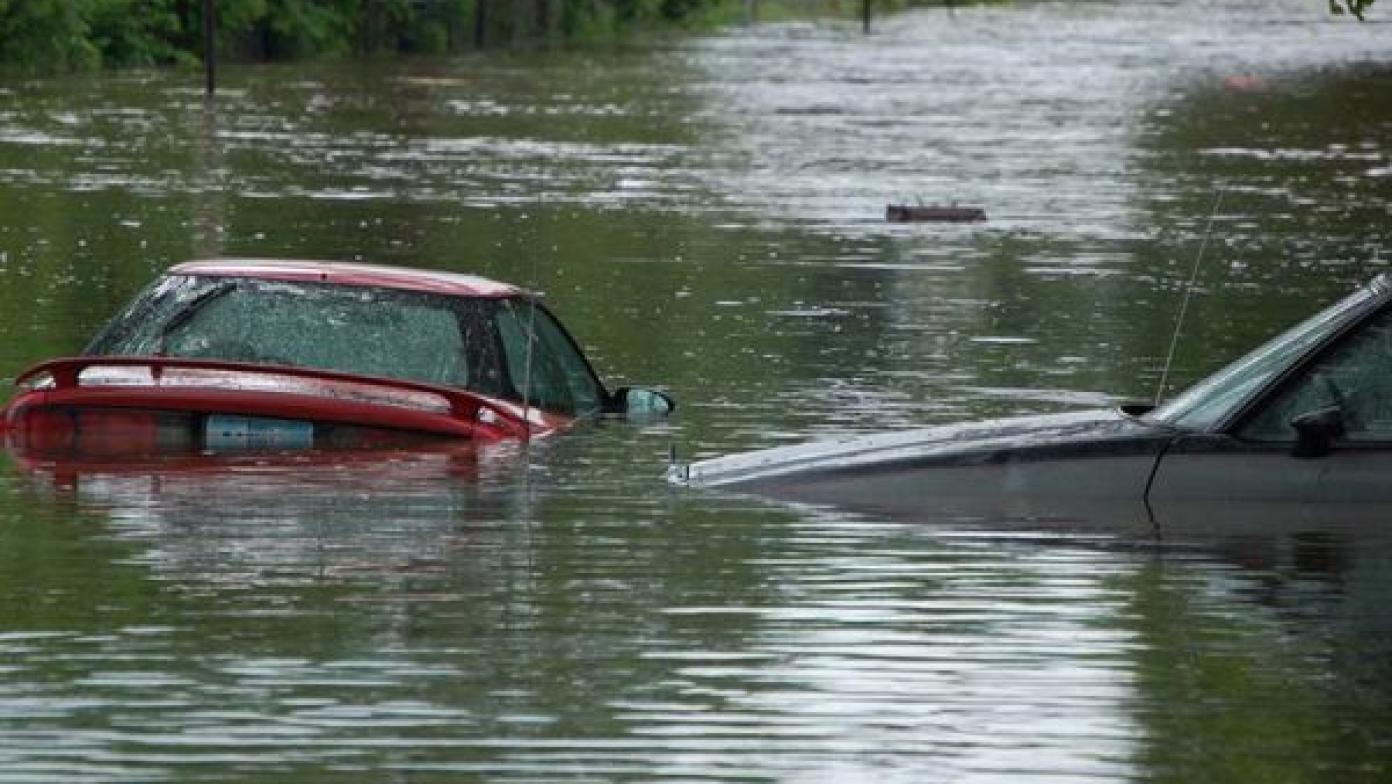 Cars floating in deep water during a flood