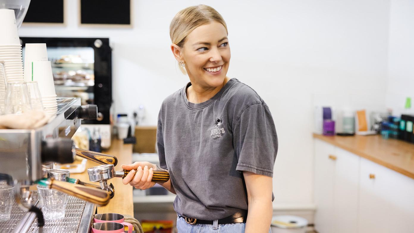Barista prepares a coffee at a cafe