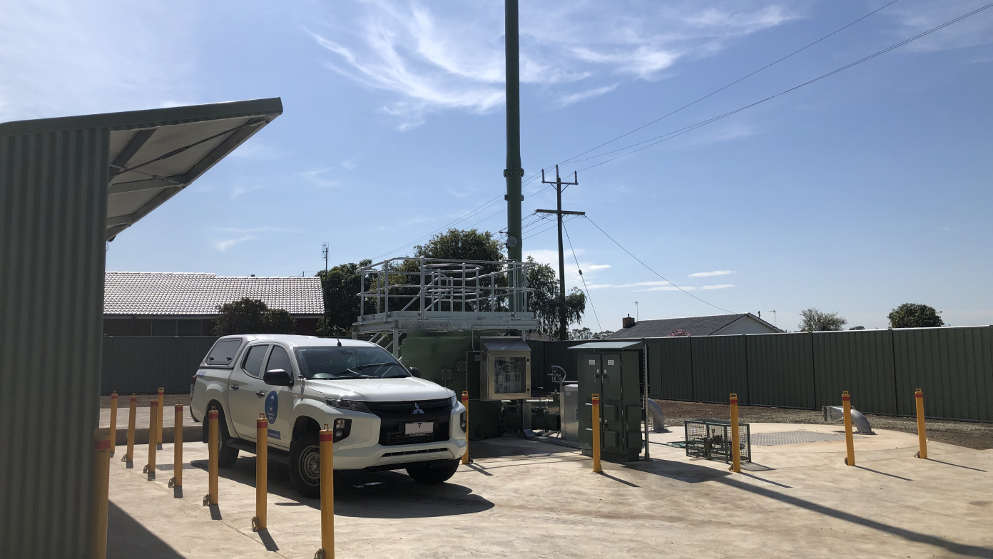 Gippsland Water car parked in front of machinery. 