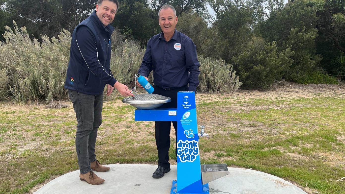 Gippsland Water general manager of people and customer Michael Crane and Wellington Shire Mayor Ian Bye try out the new fountain at Seaspray pump track. 