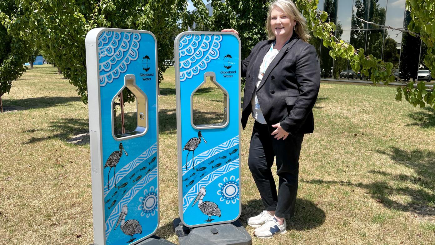 Managing director Sarah Cumming stands to the left of two water fountains