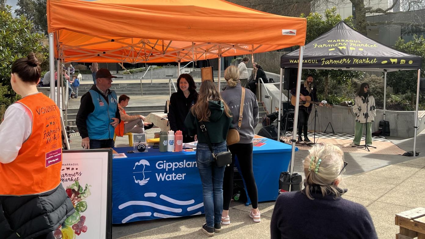 Gippsland Water staff speaking with community members at the Warragul Farmers Market in 2024.