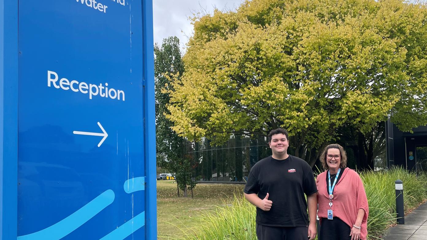 Two Gippsland Water employees standing in front of the Traralgon head office. 
