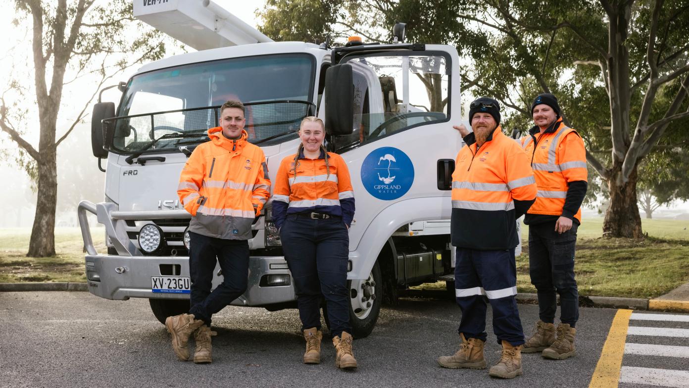 4 multiskilled operators standing in front of a Gippsland Water truck