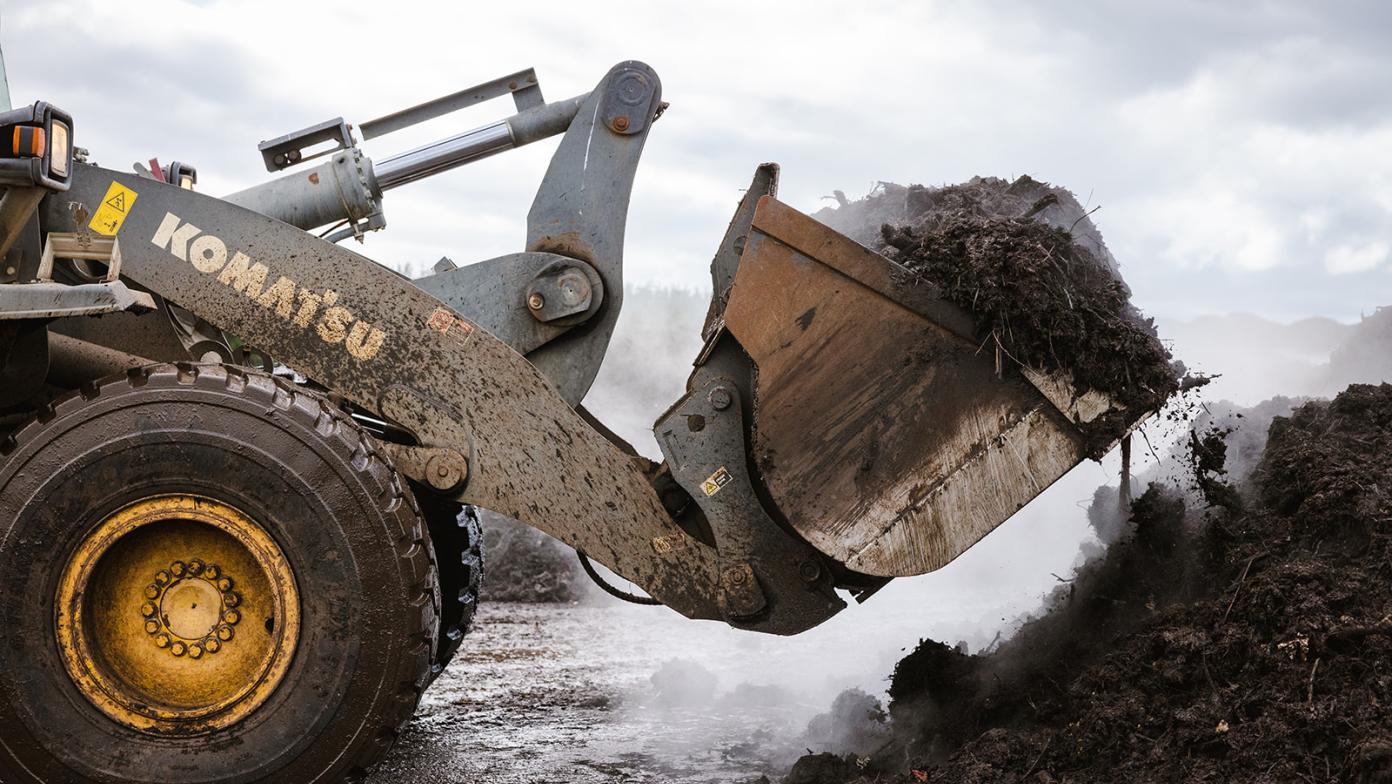 Tractor moving compost
