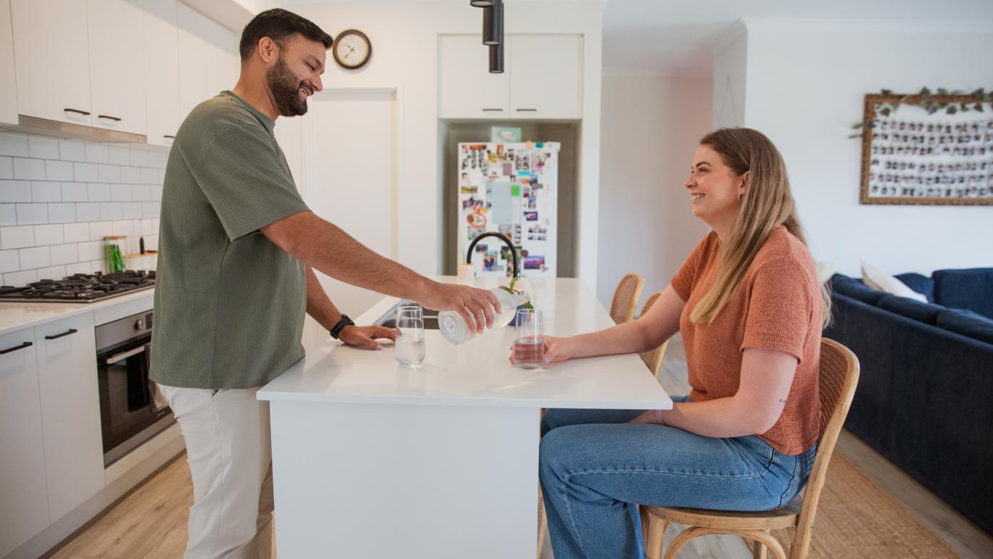 Two people at a kitchen bench