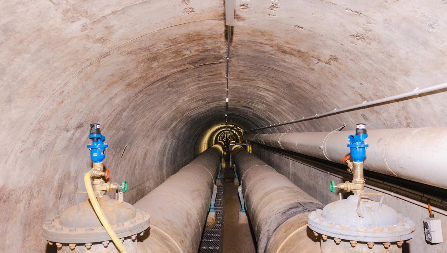 Tunnel below Moondarra Reservoir featuring two large pipes on either side