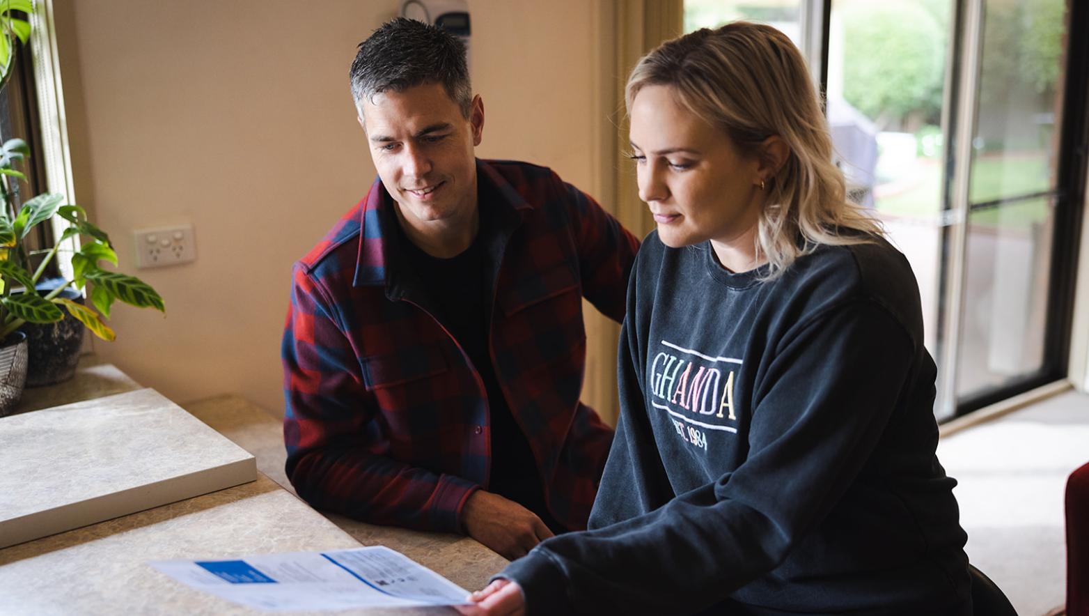 Man and woman look at Gippsland Water bill. 