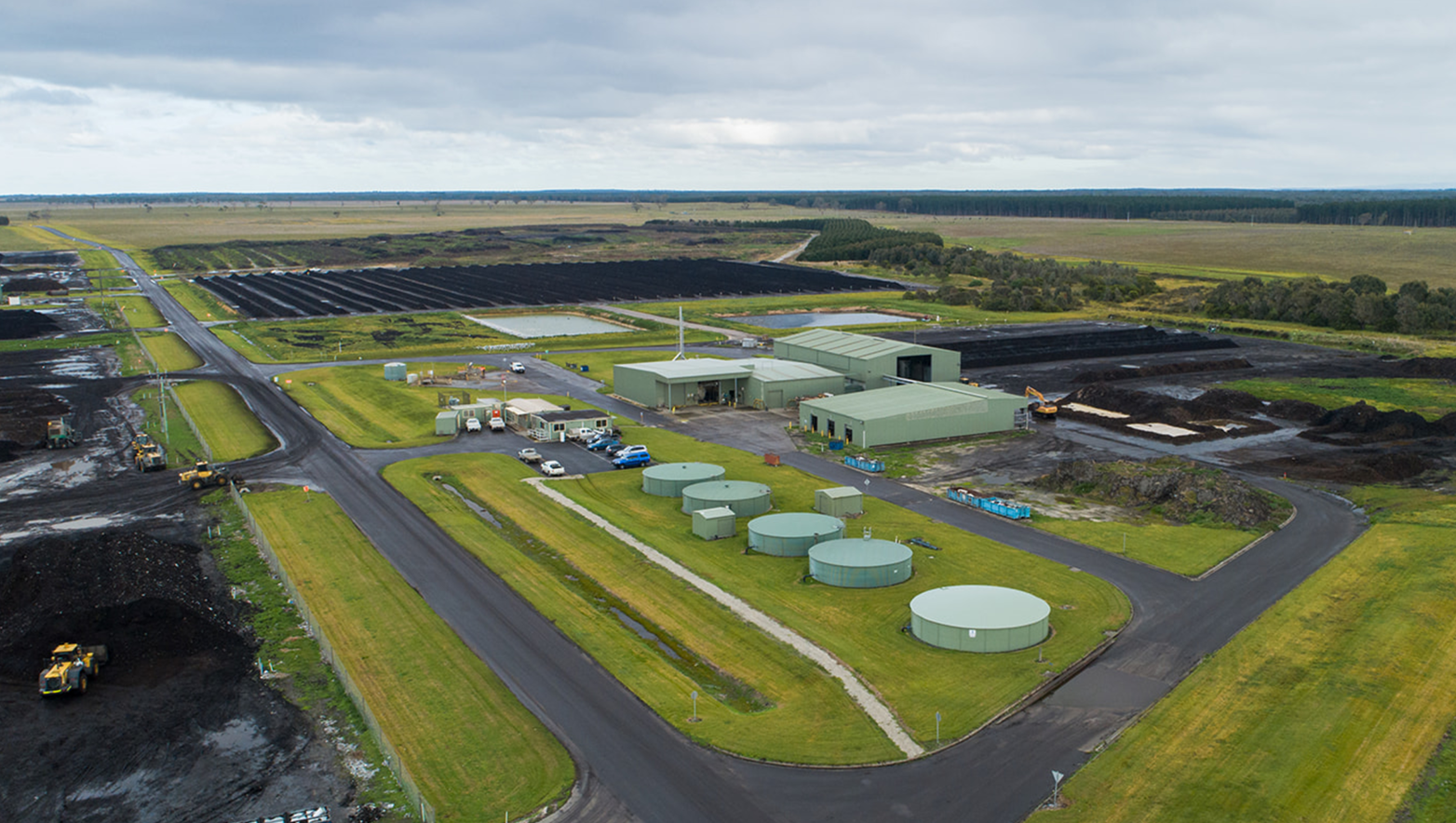 Aerial view of Gippsland Regional Organics featuring roads, windrows, trucks and tractors