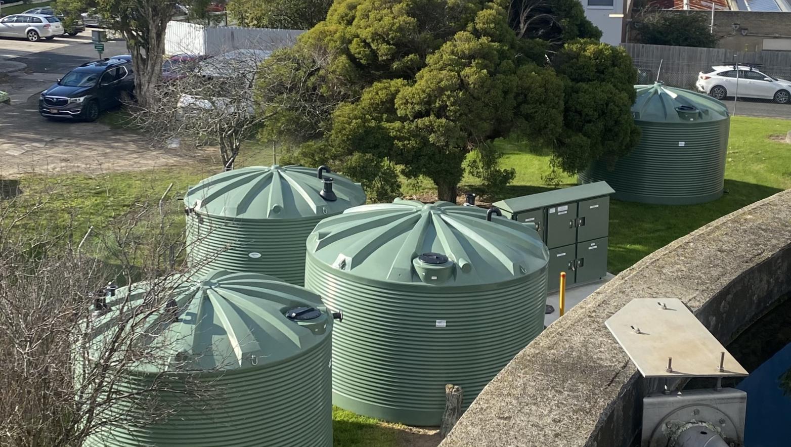 green tanks sit on grass
