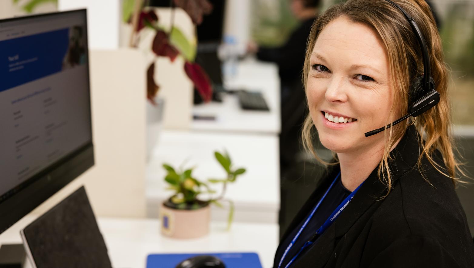A customer care team member helping a customer experiencing financial difficulty over the phone.