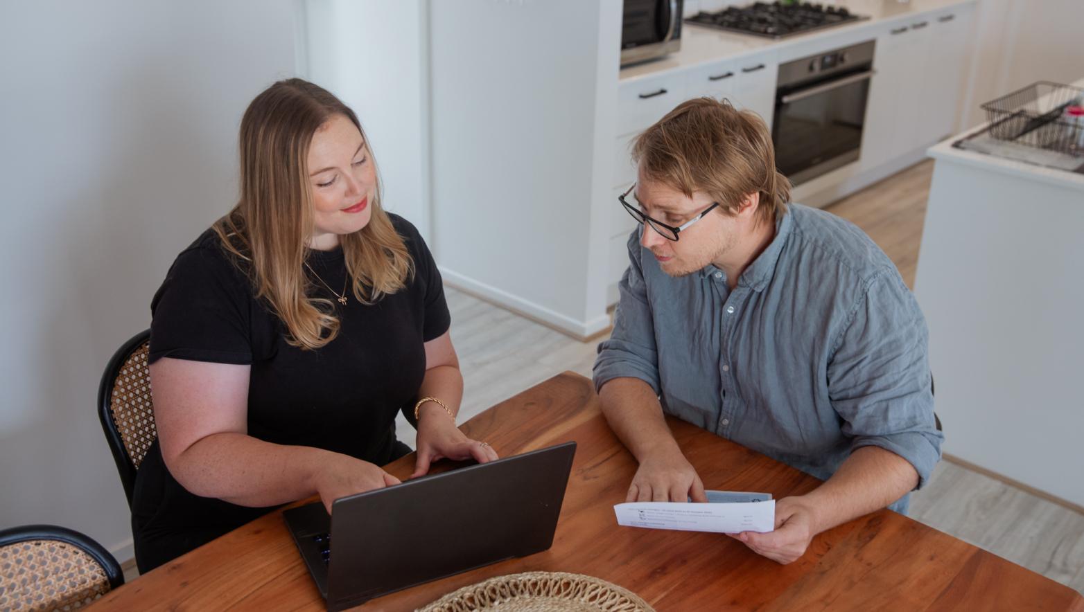 Two people looking at a laptop screen.