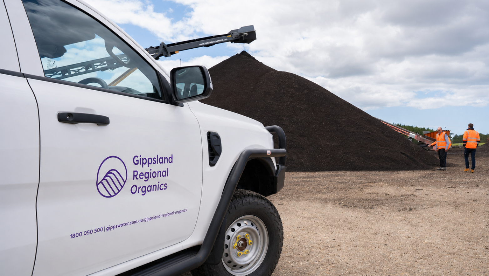 Gippsland Regional Organics vehicle in front of a pile of compost