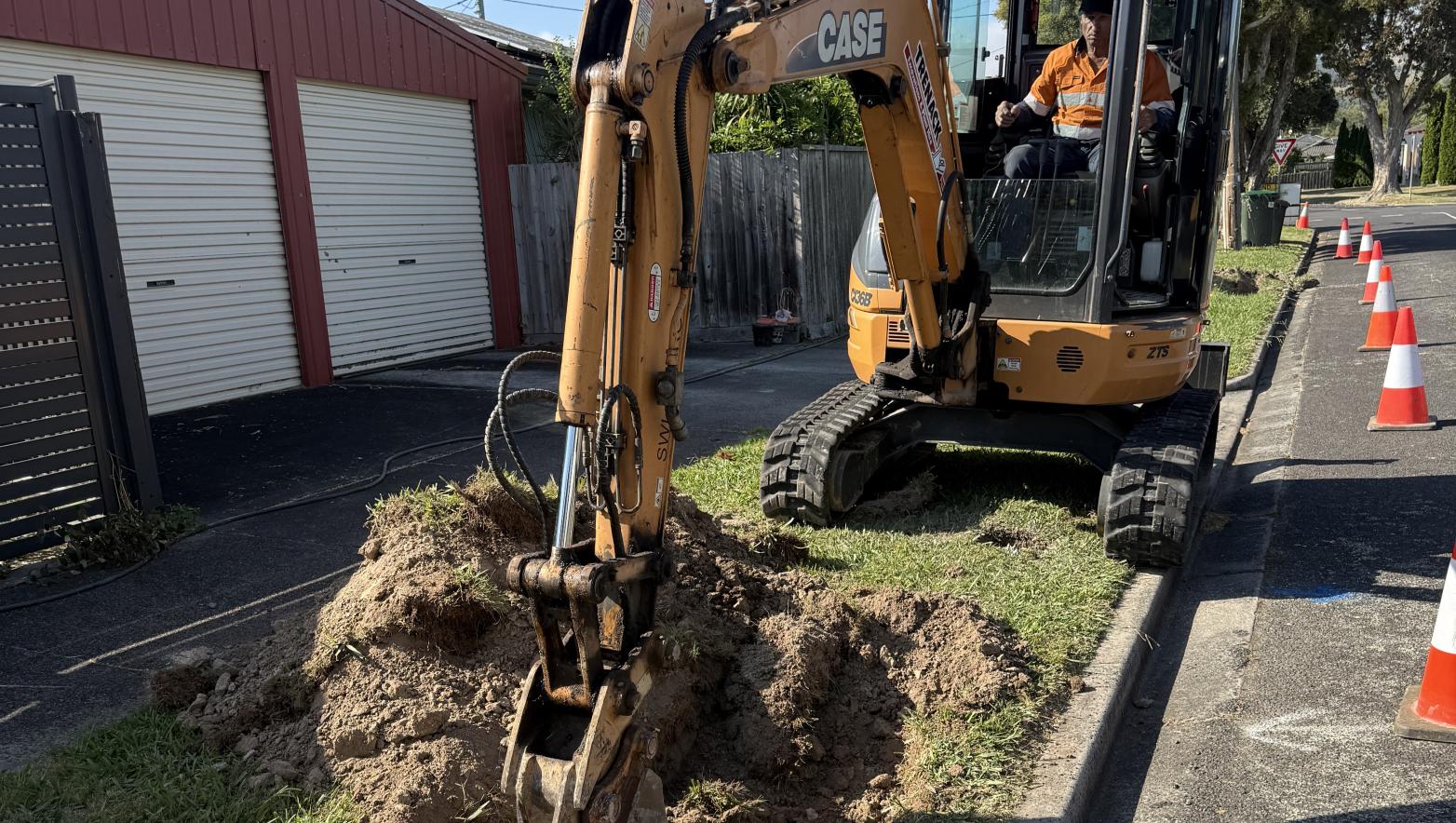 Excavator digging trench