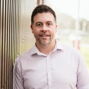 Michael Crane, General Manager People and Customer, smiling at the camera