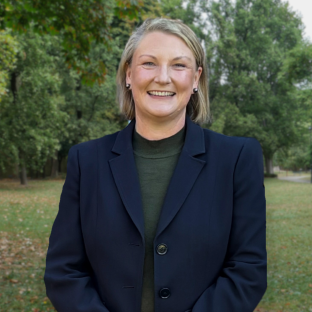 Professional headshot of Sarah Cumming standing at a park